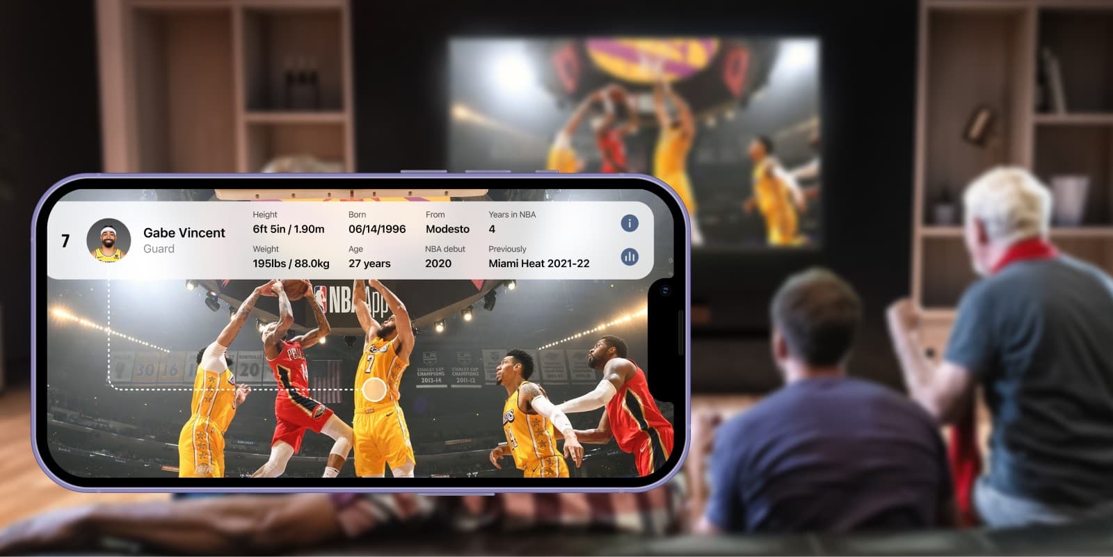 Phone with a basketball app in front of fans watching TV