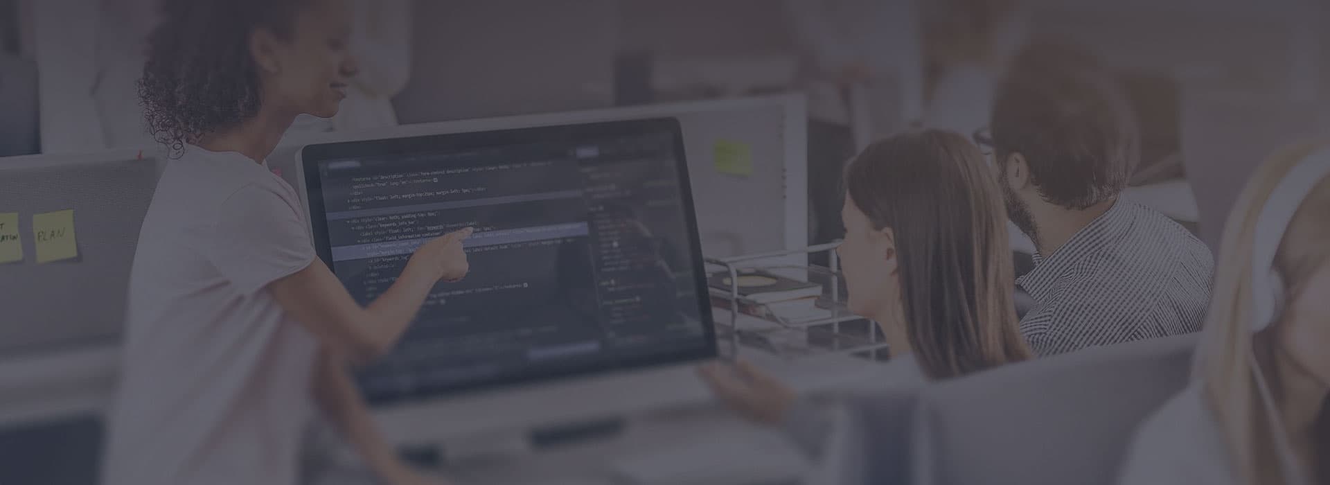 Team in an office with a web portal on a monitor