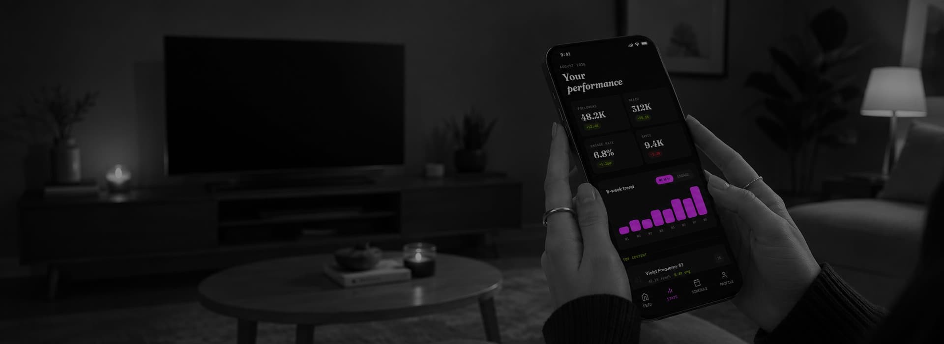 Phone showing a streaming app in a dark living room